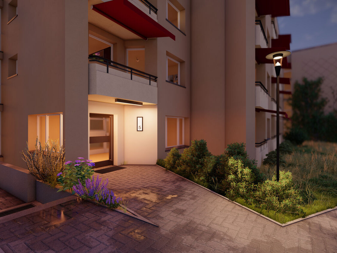 Visualisierung eines beleuchteten Hauseingangs einer Wohnanlage in der Dämmerung mit Wegbeleuchtung, bepflanzten Beeten und angrenzenden Balkonen.