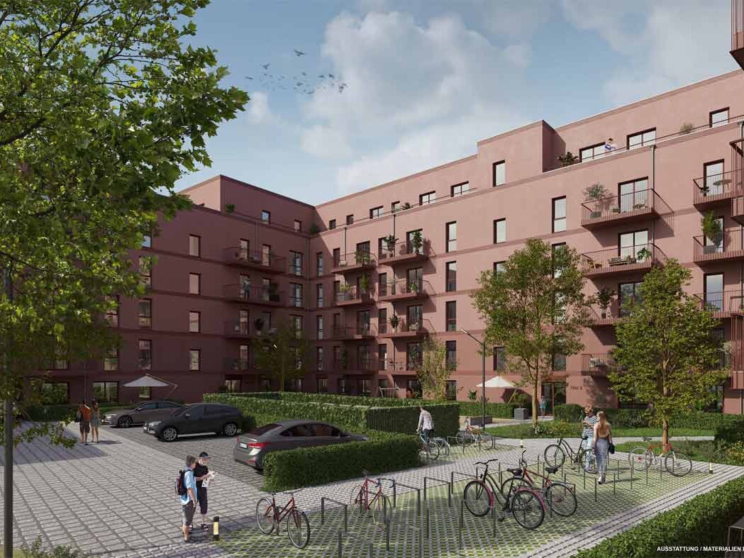 Innenhofansicht des Wohngebäudes mit Balkonen, Fahrradstellplätzen, Pkw-Stellflächen und begrünten Freiflächen.