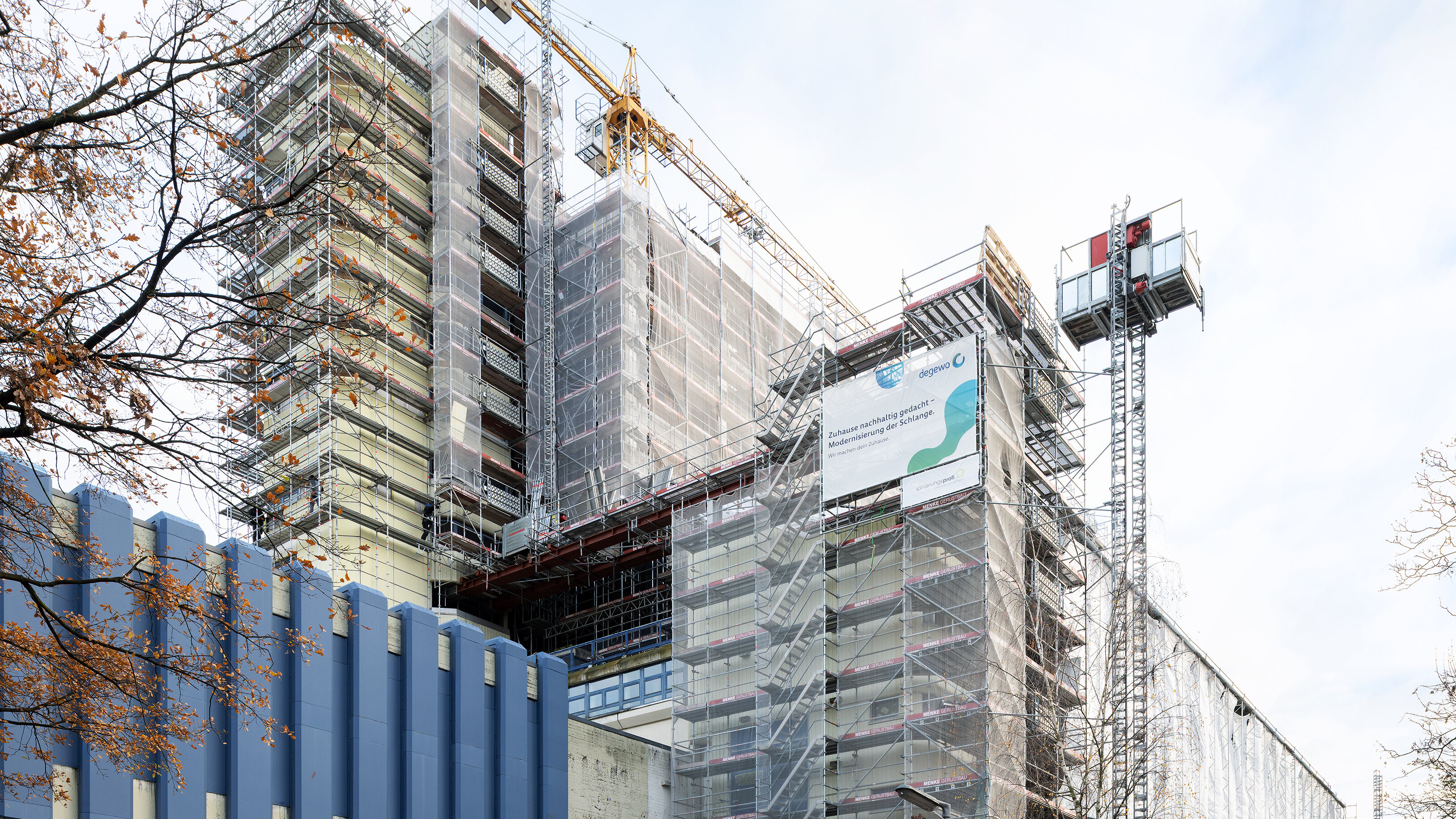 Hochhaus im Umbau mit Gerüst, Kran und Bauarbeiten an der Fassade.