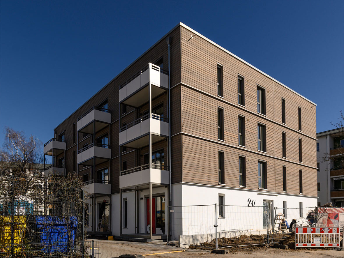 Außenansicht degewo-Neubau Am Omnibushof 2a mit Zufahrt im Vordergrund.