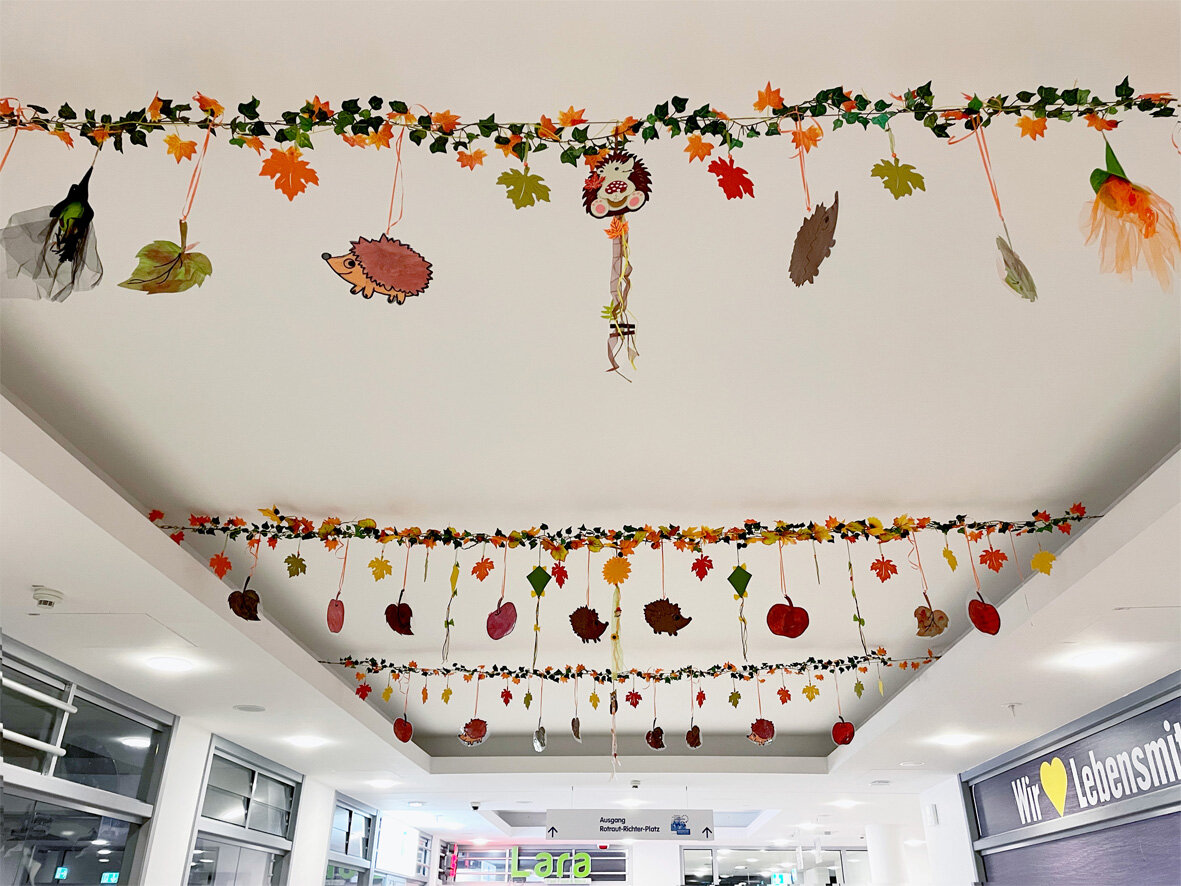 Viele Herbst-Girlanden an der Decke der Einkaufspassage im Center Wutzky