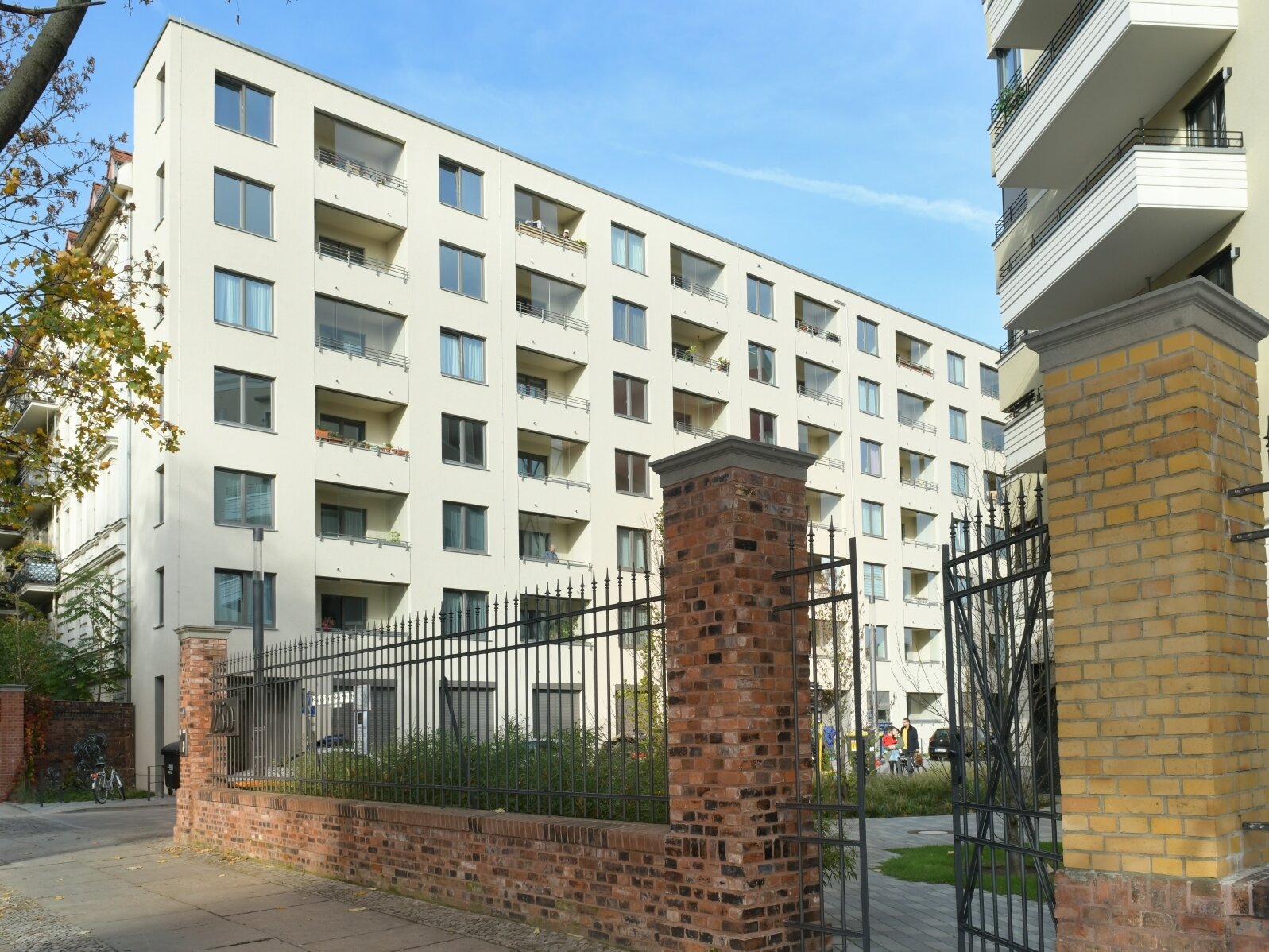 Außenansicht degewo-Neubau Klara-Franke-Straße 1 bis 7: Zufahrt mit Mauer und Zaun im Vordergrund.