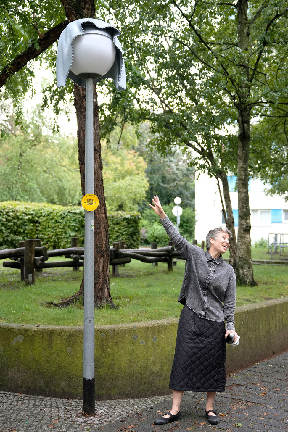 Alona Rodeh steht vor einer Laterne und zeigt auf die Nightcap-Haube.