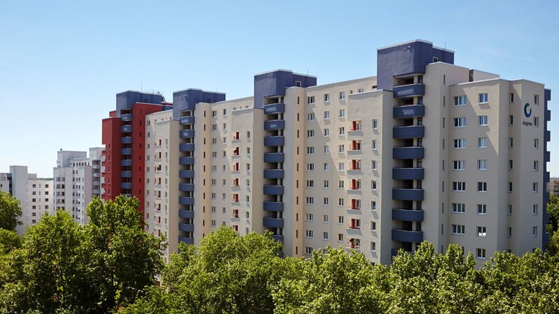 Außenansicht degewo-Ankauf Waldsassener Straße 11 und 16 bis 22 Lichtenfelder Ring 81 bis 89: Blick aus großer Entfernung mit Baumreihe im Vordergrund.