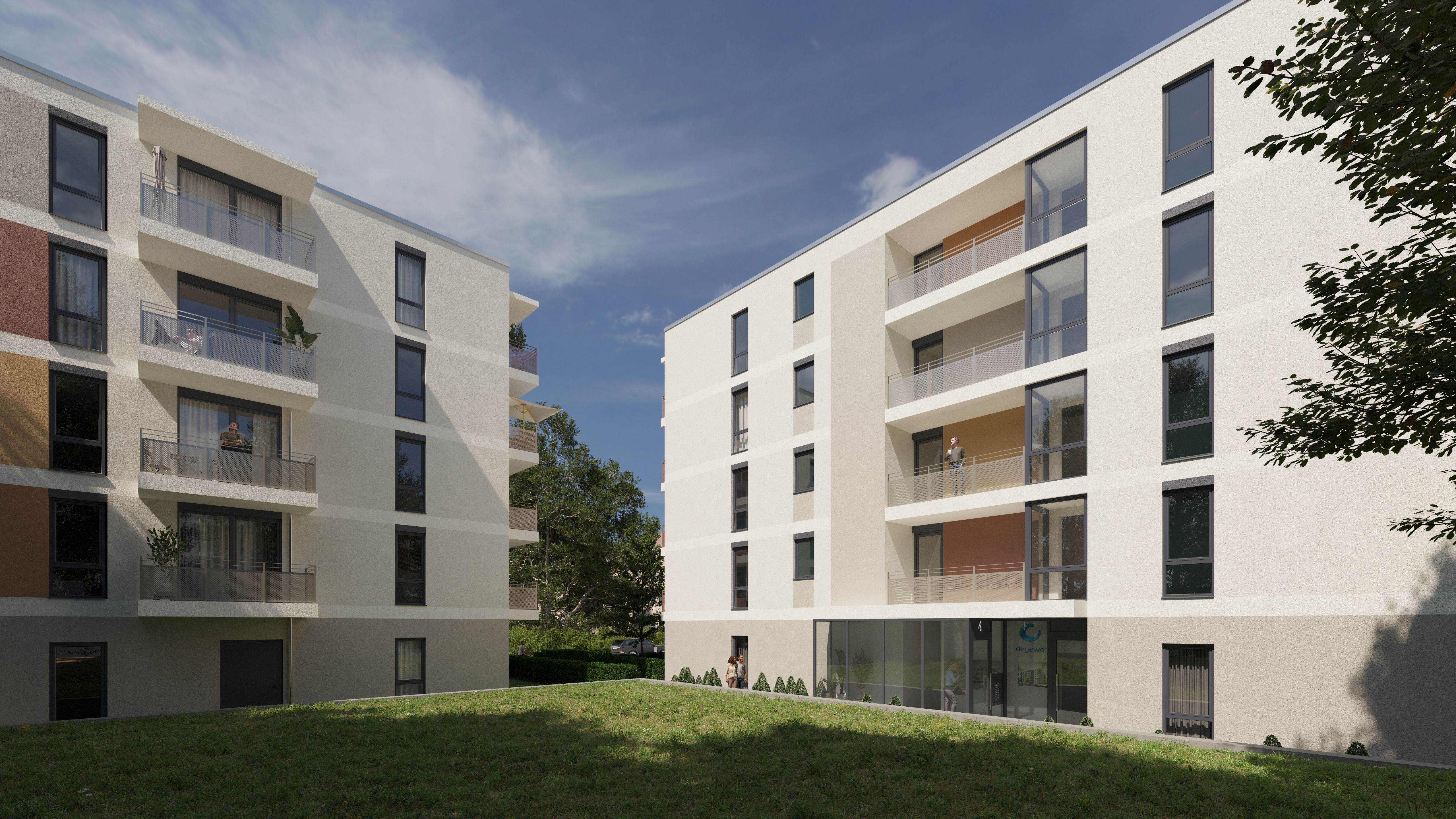 Zeitgemäße Wohngebäude mit Balkonen, großen Fensterflächen und gemeinschaftlicher Grünfläche in einem gepflegten Innenhof eines familienfreundlichen Wohnquartiers.